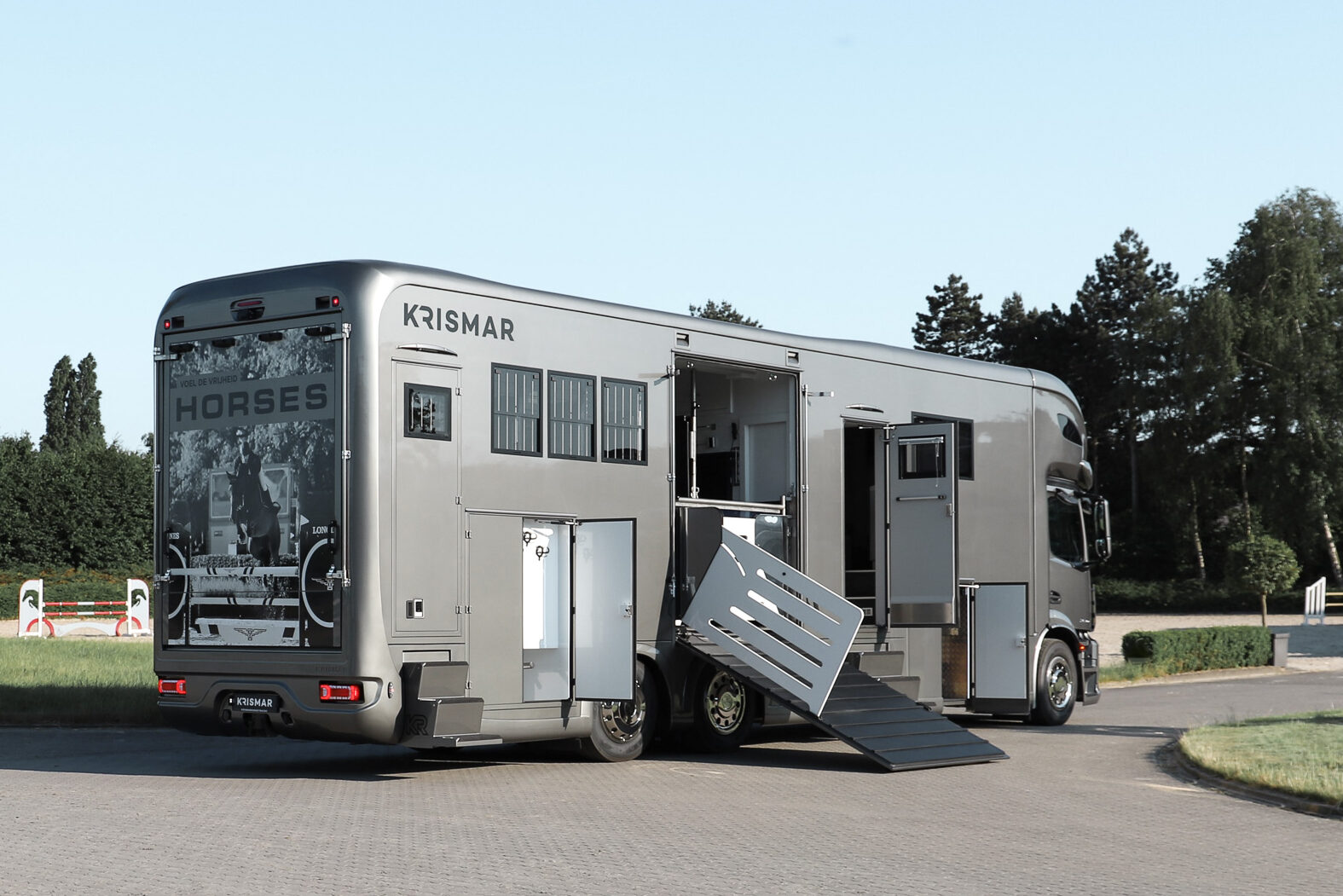 A grey Krismar horse truck with all the doors open.